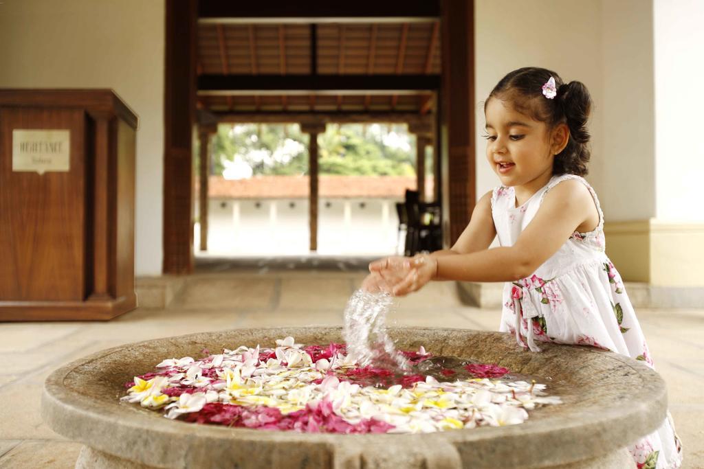 Heritage Madurai Εξωτερικό φωτογραφία A girl playing with flowers