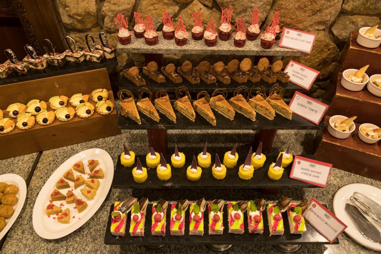Heritage Madurai Εξωτερικό φωτογραφία A selection of desserts